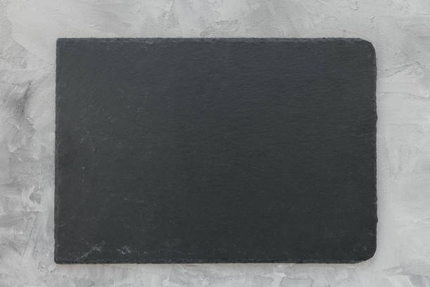 istock Black slate plate board on gray background 1356789605