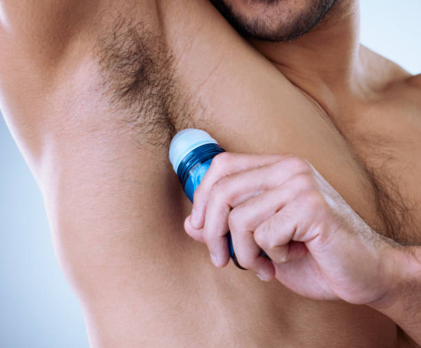 istock Cropped studio shot of an unrecognizable man applying deodorant 1356790637
