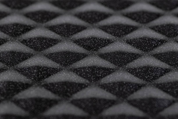 istock Background made of a macro photo with a smooth diamond-shaped black metal surface with white dots, selective focus in the center. 1356790893