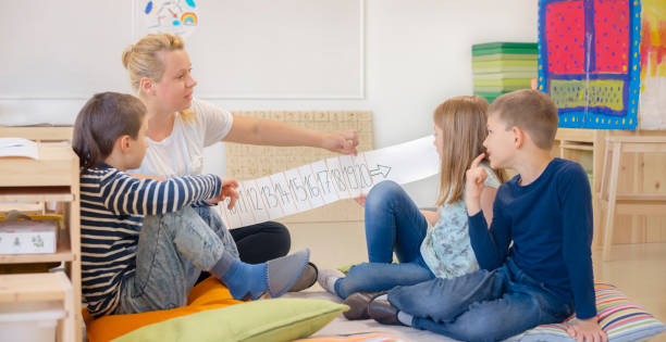 istock Female teacher teaching her student in classroom 1356791557