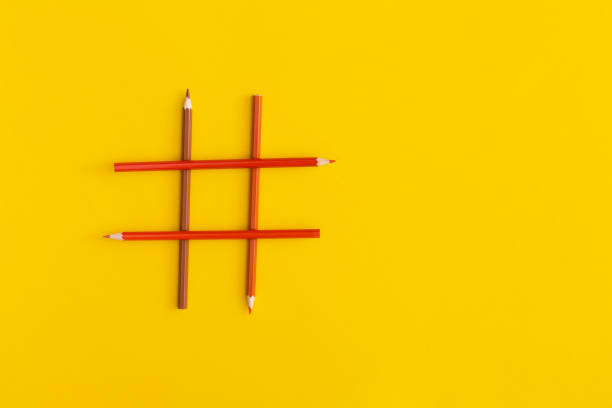 istock Hashtags sign made of colored pencils on yellow background 1356791893