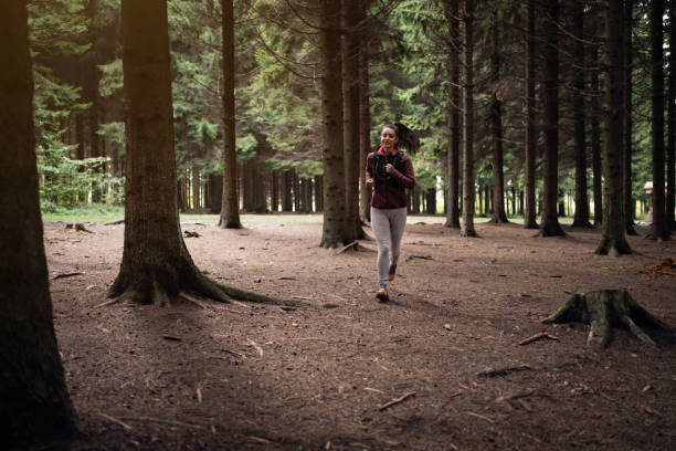istock In the Pinaceae forest, active Caucasian young woman running 1356792164