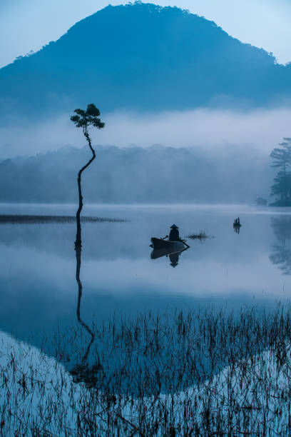 istock Fisherman in Tuyen Lam lake 1356792396