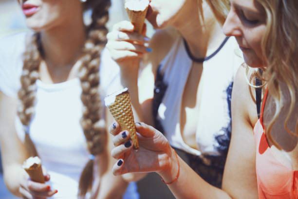 istock Girlfriends having fun and eating ice cream 1356793936