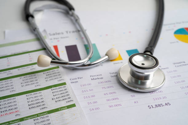 istock Stethoscope on charts and graphs paper, Finance, Account, Statistics, Investment, Analytic research data economy and Business company concept. 1356794059