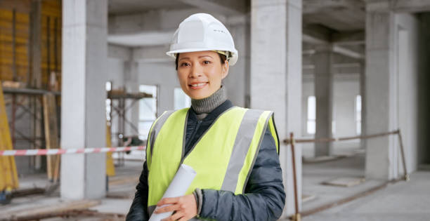 istock Close-up of smiling female architect standing at construction site 1356794918
