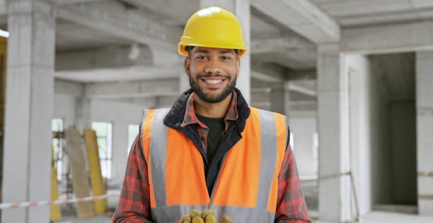 istock Close-up of smiling construction worker at site 1356794947