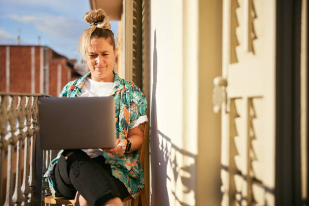 istock A woman works from home with a laptop. 1356800148