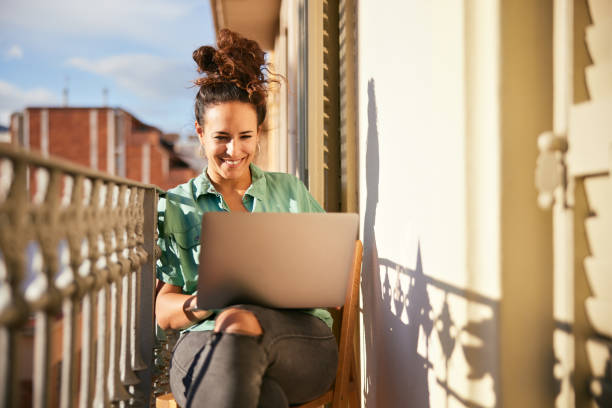 istock A woman works from home on a small balcony. 1356800152
