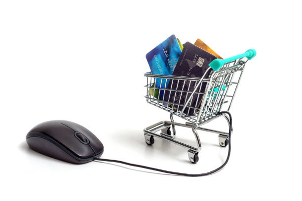 istock computer mouse and shopping cart with credit cards isolated on light background, e-commerce concept 1356802926