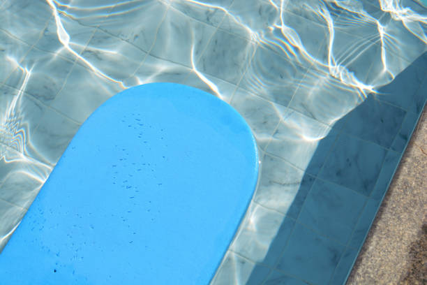 istock Blue kickboard floating on swimming pool water surface. 1356804166