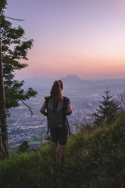 istock Female hiker relaxes on mountain at sunrise 1356804287