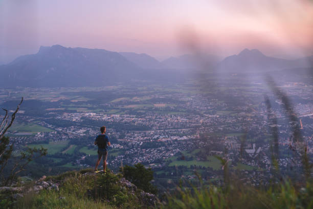 istock Hiker relaxes on mountain ridge at sunrise 1356804303