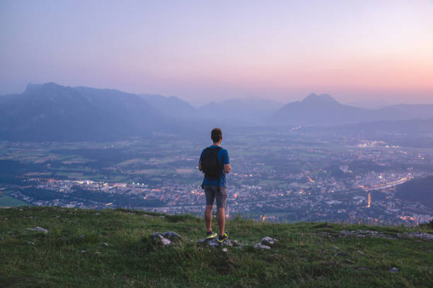 istock Hiker relaxes on mountain ridge at sunrise 1356804362