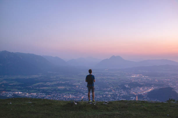 He looks off to distant Salzburg, below
