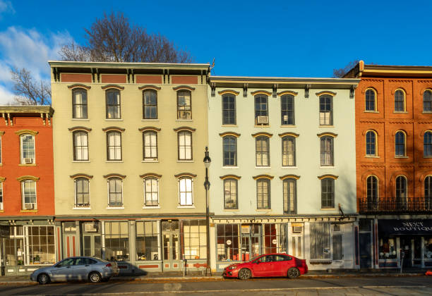 Horizontal sunrise view of the shops and cafes of West Strand Street in historic Rondout district of Kingston Kingston, NY - USA -Nov. 27, 2021: Horizontal sunrise view of the shops and cafes of West Strand Street in historic Rondout district of Kingston, New York logan west stock pictures, royalty-free photos & images