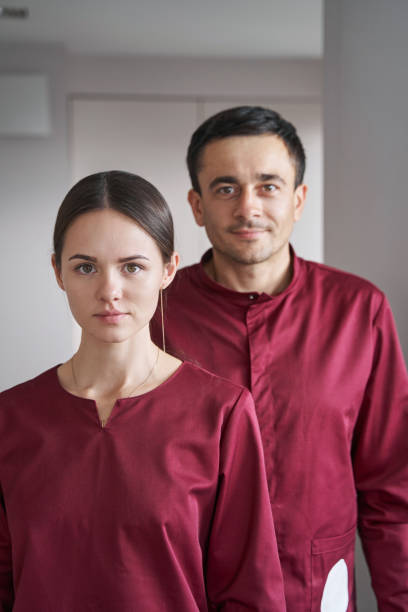 istock Janitorial personnel in uniforms posing for camera 1356804968