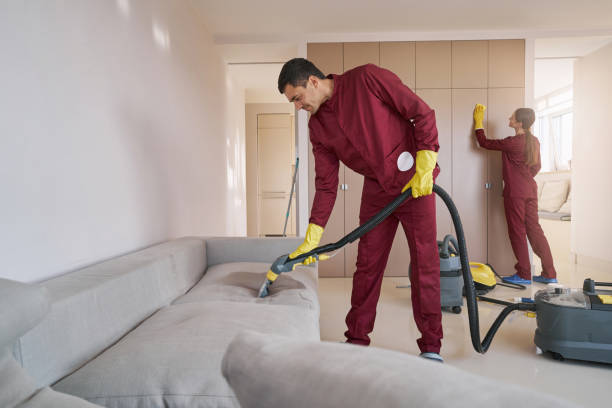 Skilled uniformed Caucasian janitorial personnel doing cleaning