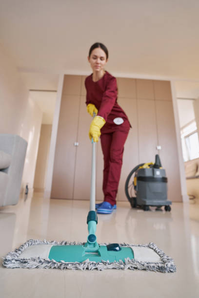 istock Skilled uniformed female janitor focused on mopping 1356805180