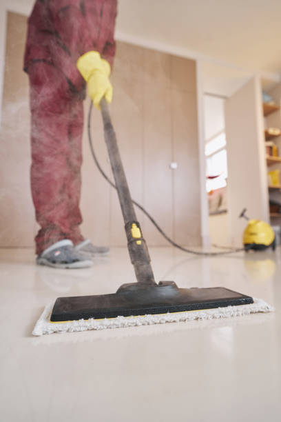 istock Janitor in rubber gloves using steam-cleaning equipment 1356805691