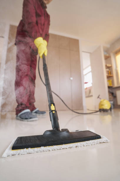istock Professional cleaner in rubber gloves using steam-cleaning appliance 1356805693