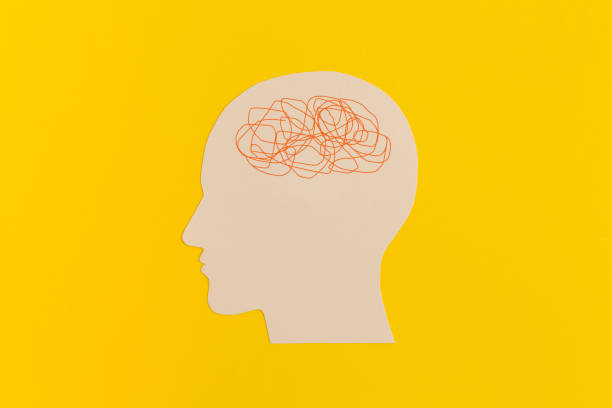 istock Human head with confused thoughts on yellow background 1356805771