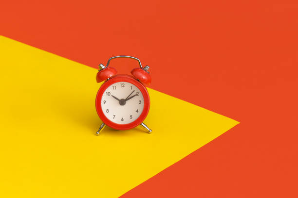 istock Red alarm clock on color background 1356805844