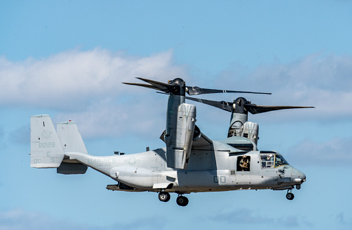 The V-22 Osprey is a transport aircraft used by the US Marine Corps. It features tilt rotors that enable it ti takeoff and land vertically like a helicopter and fly like an airplane. This image shows the rotors tilted to the vertical position for landing.\nSanford, Florida, USA\n10/17/2021