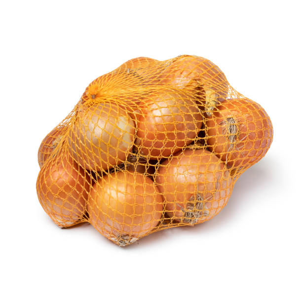 Package of fresh raw brown onions in a net on white background