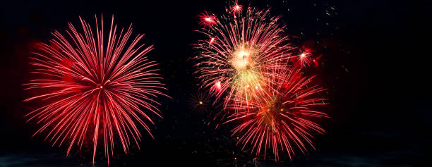 istock Colorful fireworks on black background. Celebration and holidays concept. Independence Day 4th of July, New Year, festival. Bright explosions of lights in sky. 1356813485
