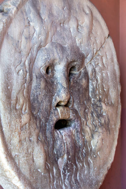 mouth of truth, great marble mask, which is located in the portico of the church of santa maria in cosmedin, rome, italy - mythology marble close up architecture imagens e fotografias de stock