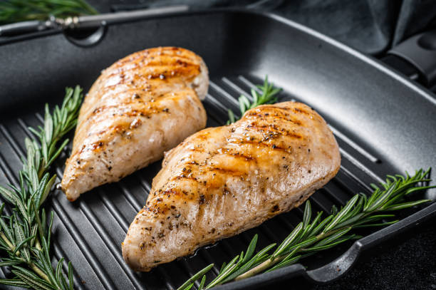 istock Grilled healthy chicken breasts cooked on a grill pan. Black background. Top view 1356815177