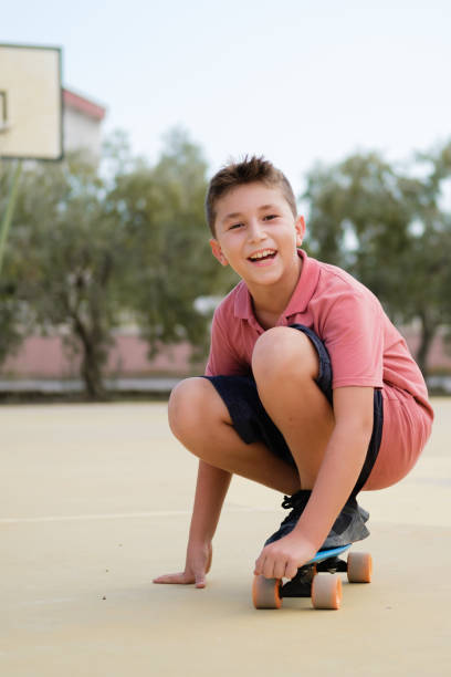istock A young boy skateboarding in the street. 1356815191