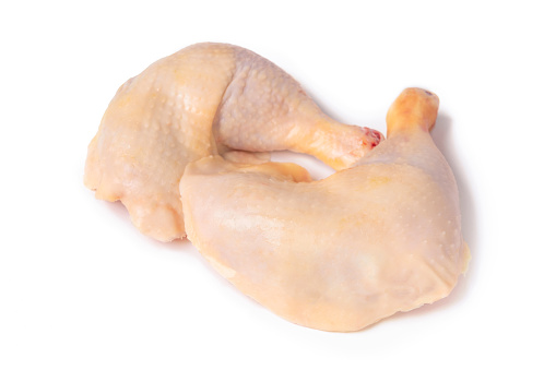 Two chicken legs isolated on a white background, top view. Natural farm meat from a poultry farm