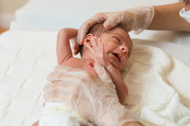 istock Professional physiotherapist performing a sternocleidomastoid evaluation in a newborn baby. 1356816103