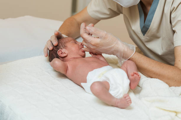 istock Professional physiotherapist performing a suction assessment in a newborn baby. 1356816113