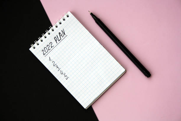 istock 2022 notebook mockup on pink background. New Year. Plans, goals for 2022 1356817182