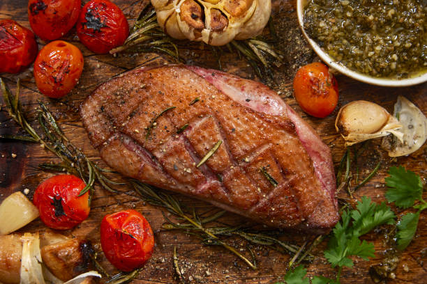 Pan Seared Crispy Duck Breast with Roast Cherry Tomatoes Garlic, Rosemary  with Basil and Cilantro Pesto