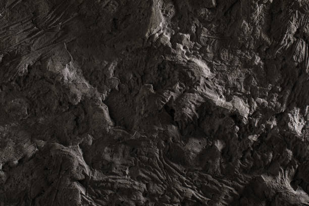 istock Grey textured clay wall design with cracks and imperfections. Wall design ideas in contemporary interior. 1356818820