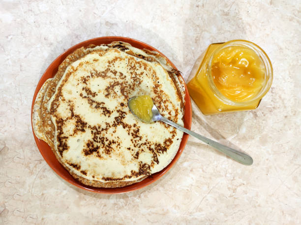 istock pancakes, spoon and jar with honey, top view 1356819988