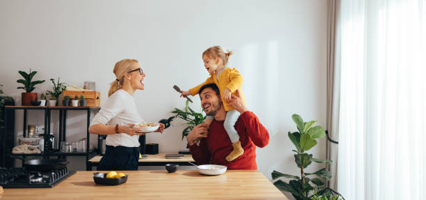 Family Playing While Having a Healthy Breakfast in the Kitchen