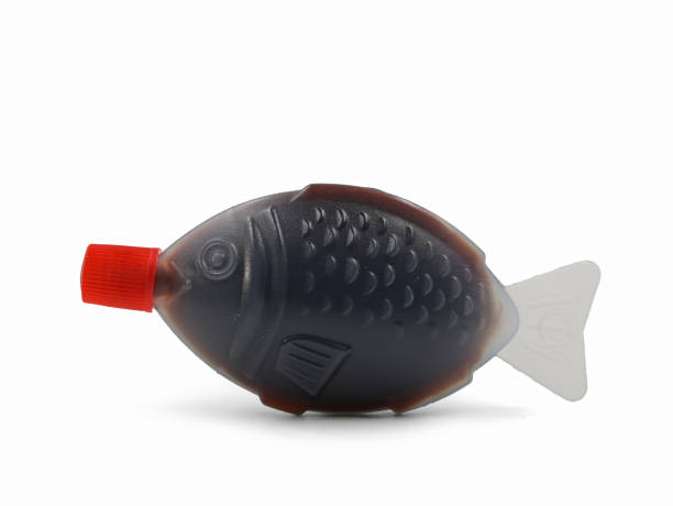 istock Fish shaped plastic takeaway container serving of soy sauce isolated on a white background 1356820964