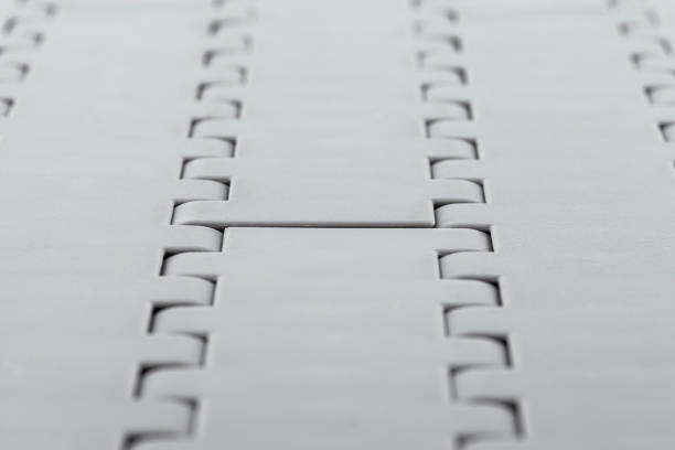 Background made from a macro photo of a plastic conveyor belt combined into sections, selective focus in the center.