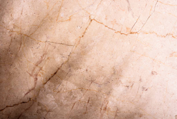 istock Luxury beige marble background with tropical palm leaf shadow. Top view. Natural organic material with sunshine light. 1356825288