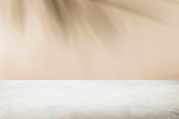 istock Tropical palm tree shadow on cream wall and luxury marble table for product placement. Natural layout design background. 1356825393