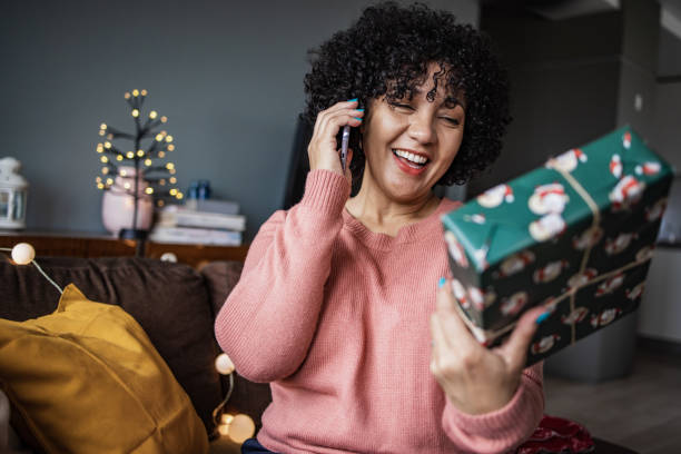 istock Woman talking on the phone during Christmas 1356826184