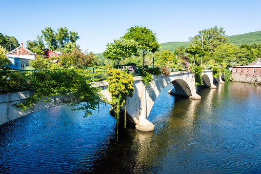 Bridge of Flowers in Shelburne Falls, Massachusetts, USA. The Bridge of Flowers is a former trolley bridge over the Deerfield River that is now maintained by the Shelburne Falls Women's Club as a floral display from April through October.
