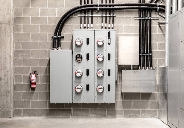 istock Electrical room with multiple smart meters, cabinets, wiring and fire extinguisher. 1356829357
