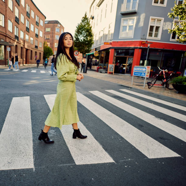 istock Young Asian woman crossing road 1356830295