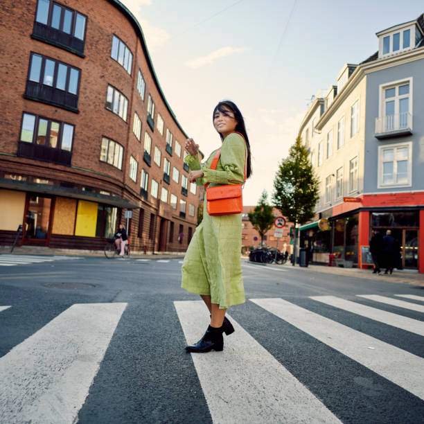 istock Young Asian woman crossing road 1356830303